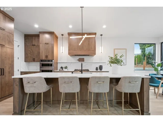 a kitchen with a dining table chairs sink and granite counter top