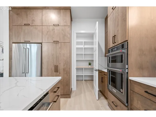 a kitchen with kitchen island a counter top space appliances and cabinets