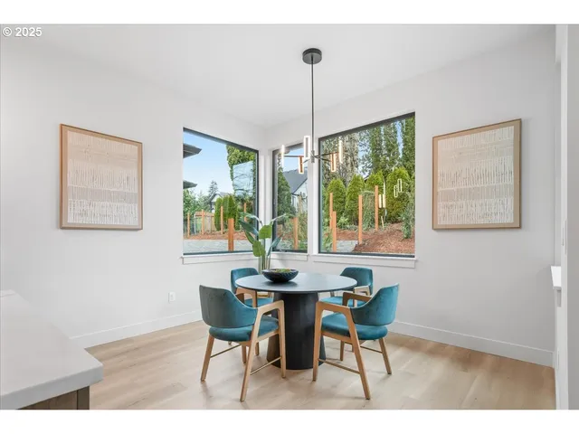 a dining room with furniture a chandelier and wooden floor