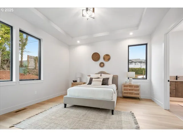 a bedroom with a bed and a large window