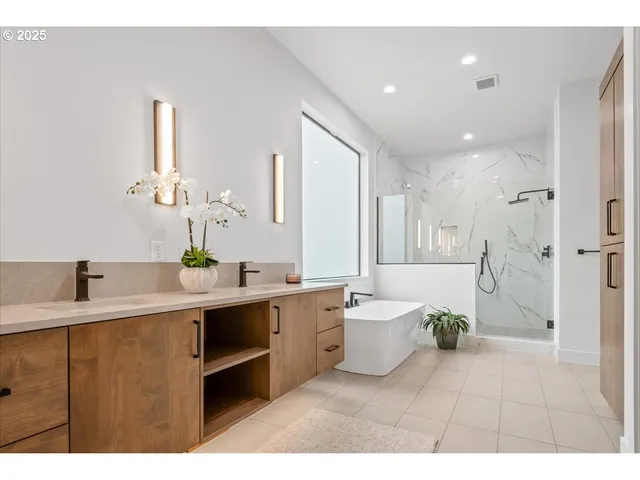 a bathroom with a tub sink and mirror