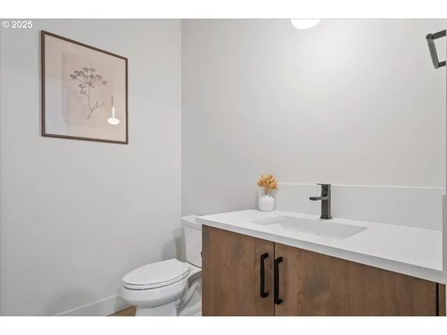 a bathroom with a sink mirror vanity and toilet