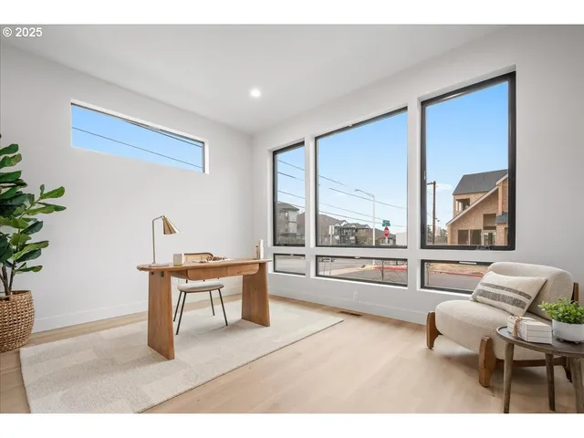 a living room with furniture a dining table and a floor to ceiling window