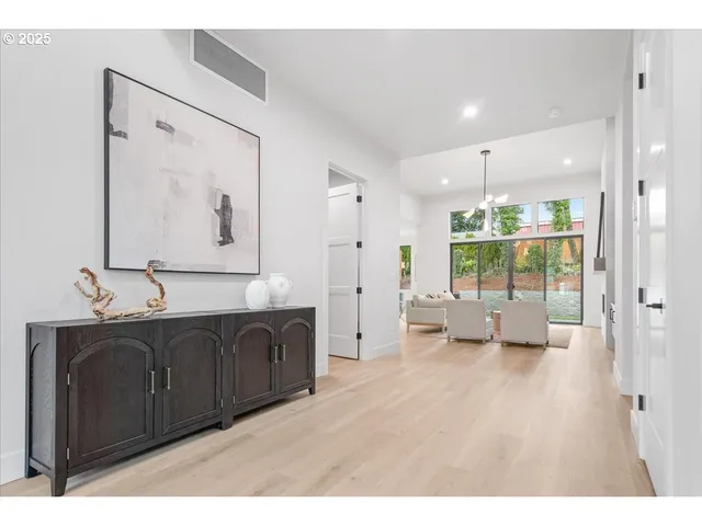 a spacious bathroom with a double vanity sink a large mirror and shower