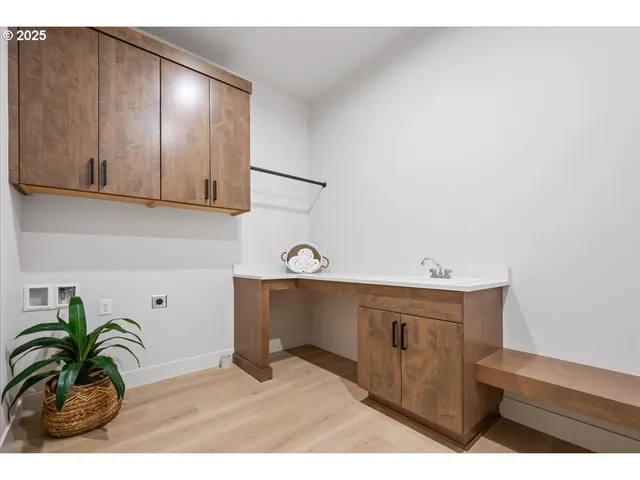 a view of a kitchen with sink and cabinets