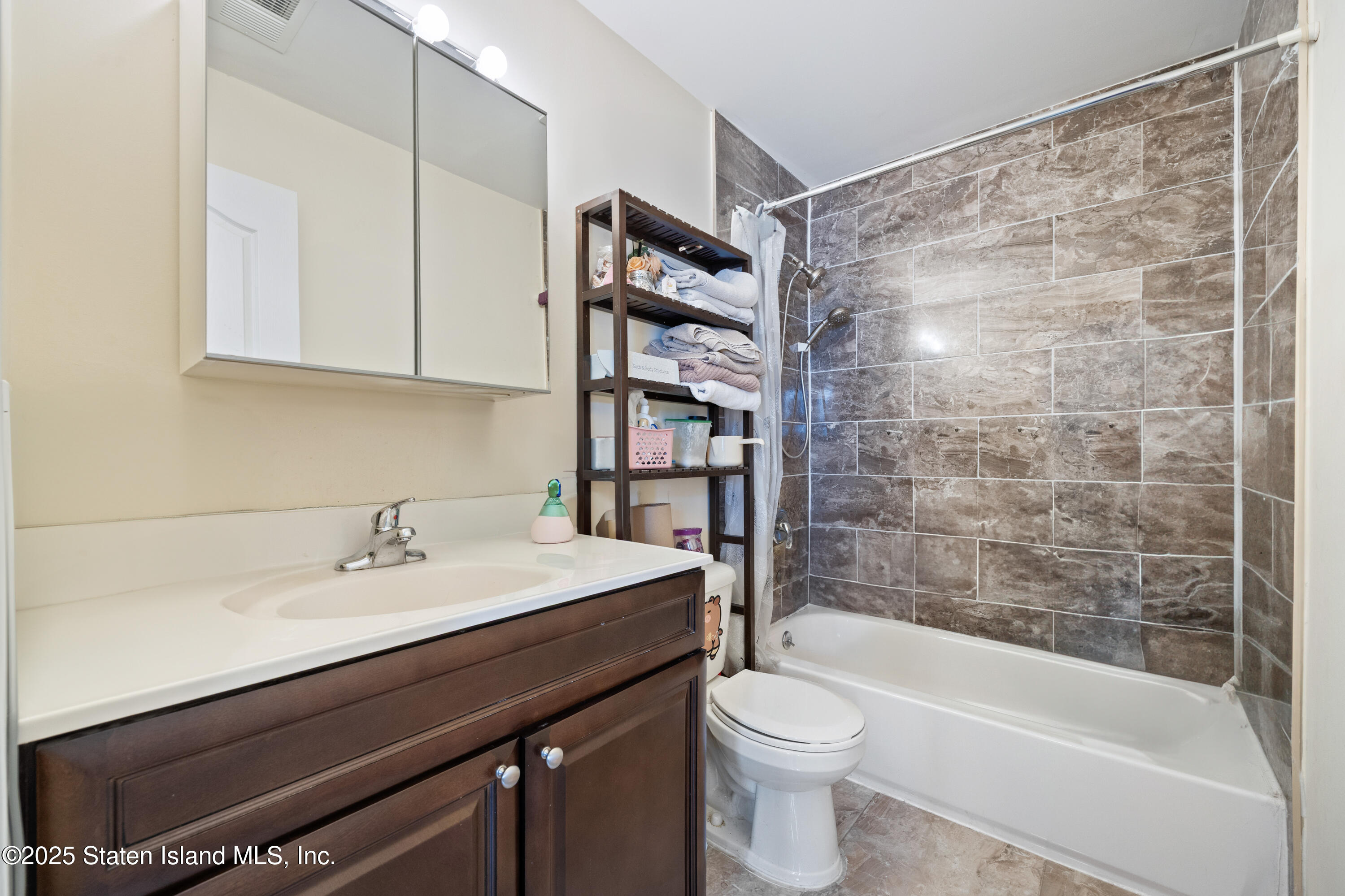 41 Burgundy Loop Staten Island, NY 10304 - Photo 11 of 29 a bathroom with a sink a toilet and shower
