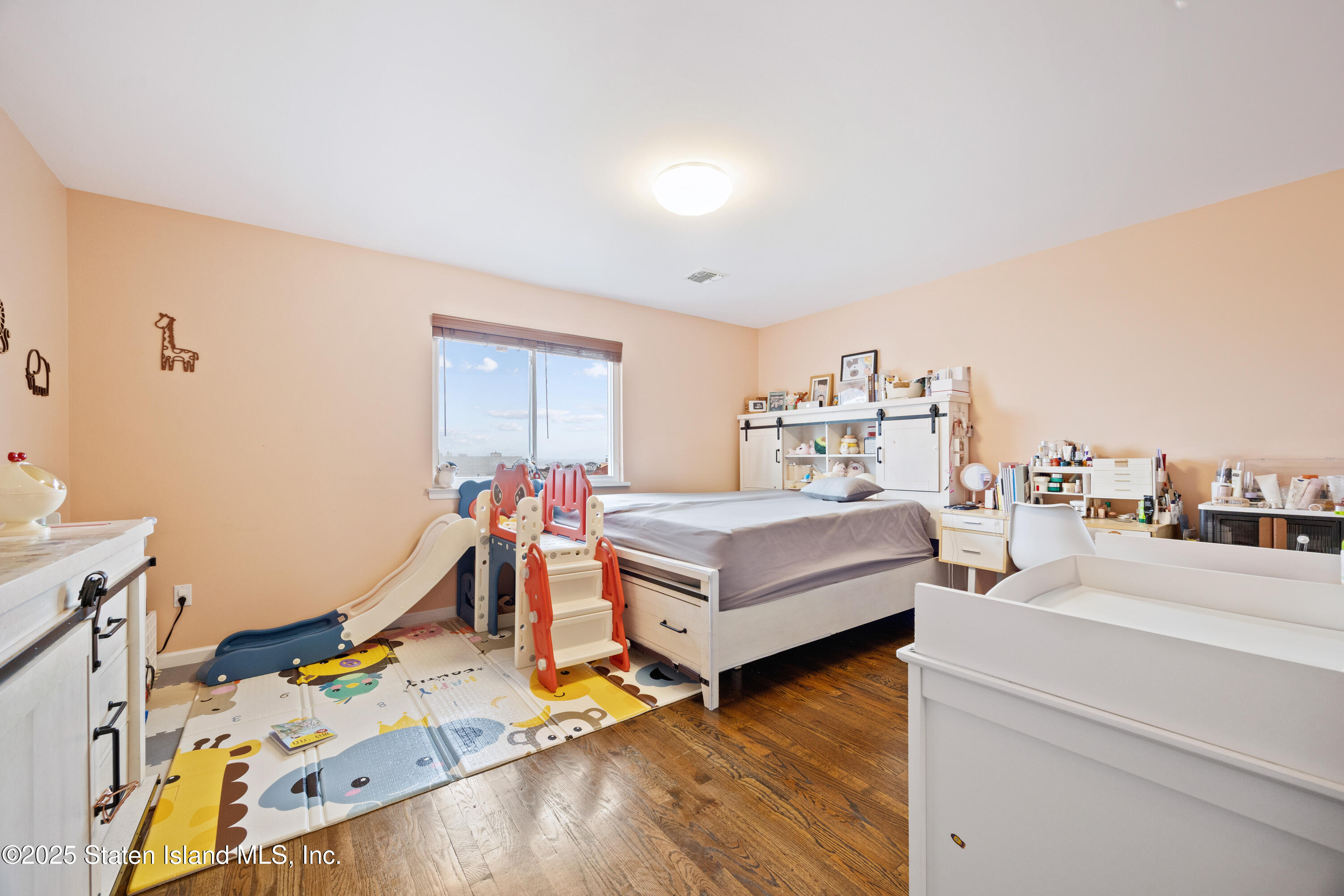 41 Burgundy Loop Staten Island, NY 10304 - Photo 12 of 29 a bedroom with furniture and a wooden floor