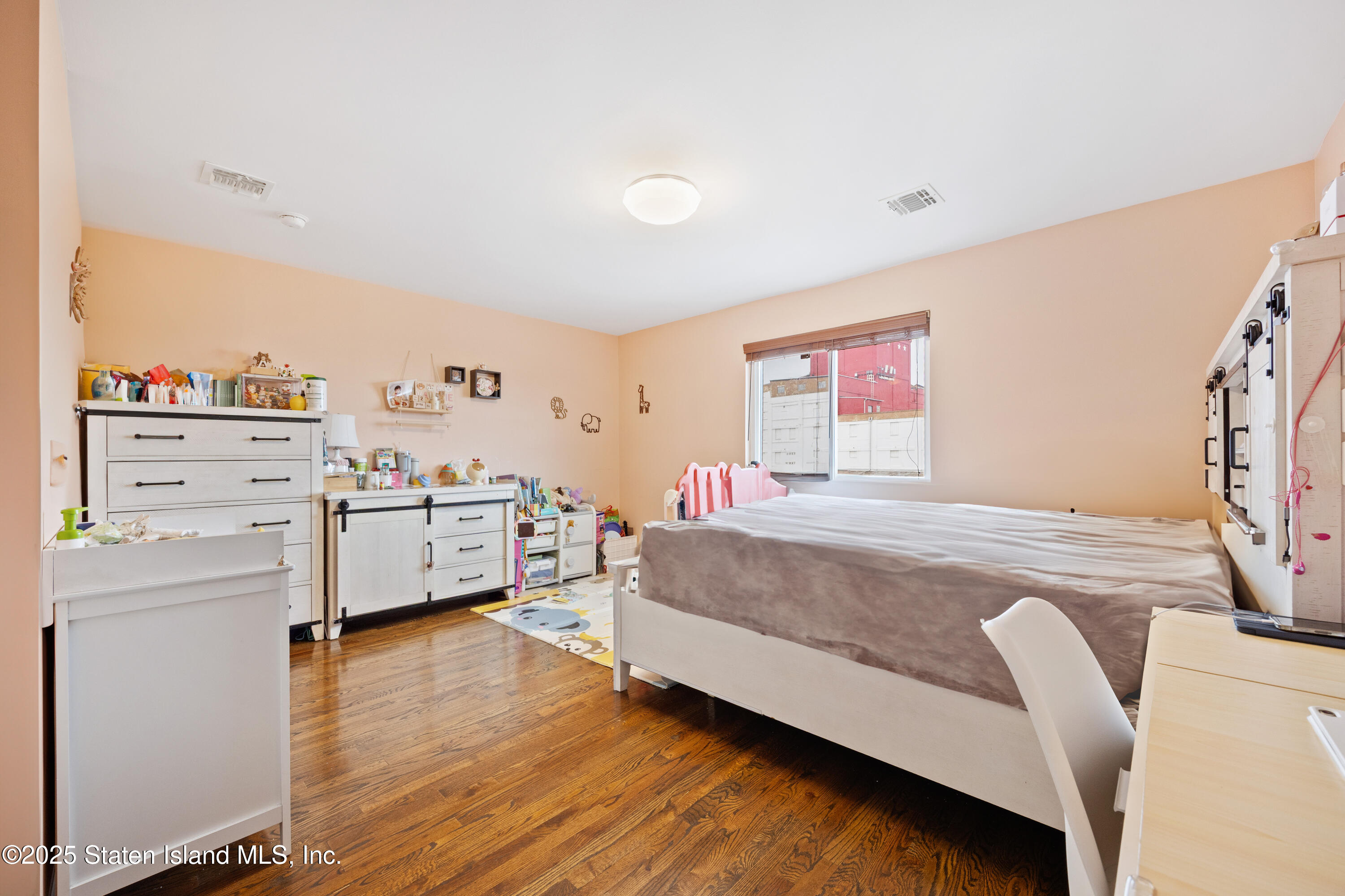 41 Burgundy Loop Staten Island, NY 10304 - Photo 13 of 29 a bedroom with a bed and a dresser