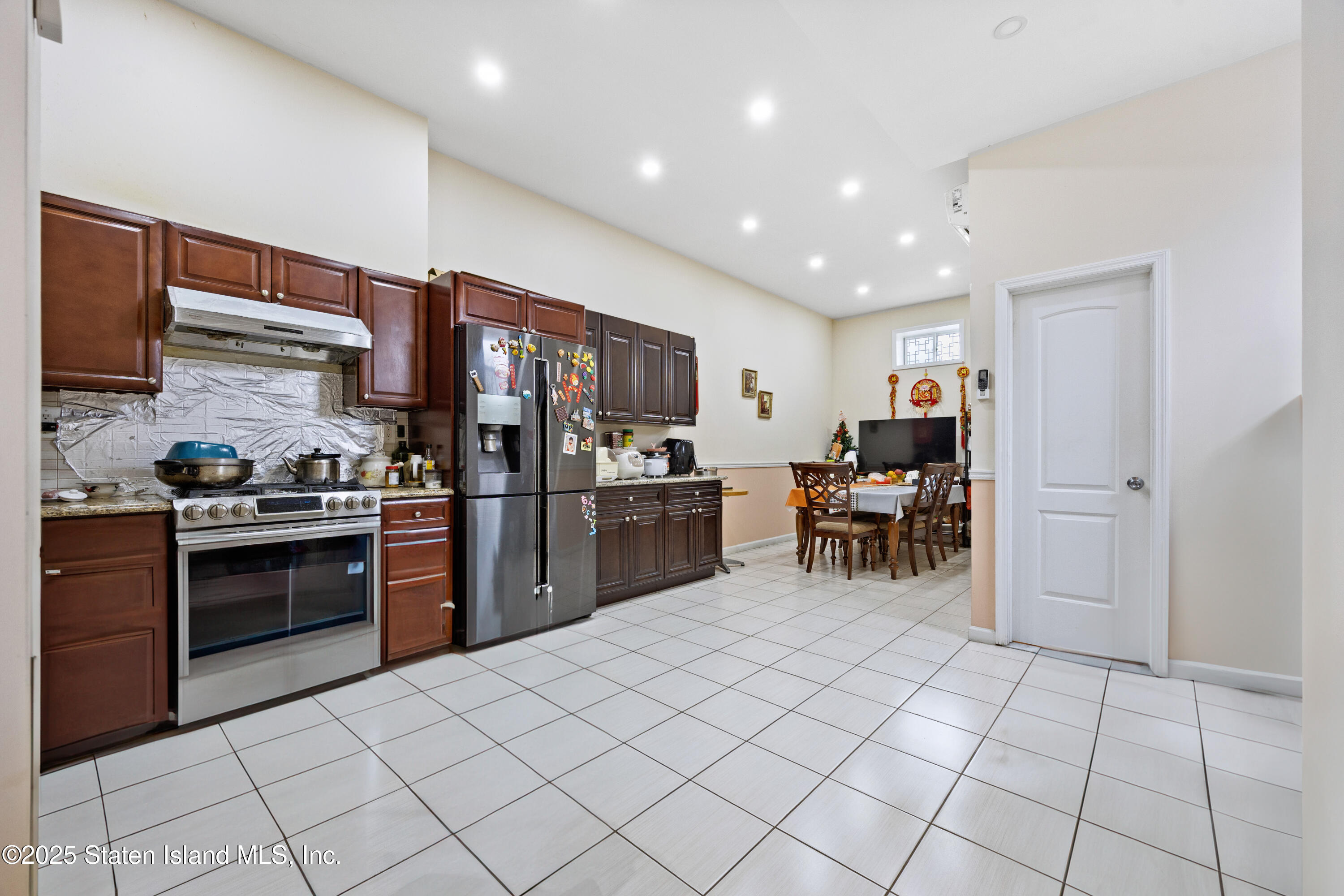 41 Burgundy Loop Staten Island, NY 10304 - Photo 16 of 29 a kitchen with stainless steel appliances granite countertop a refrigerator and a stove top oven