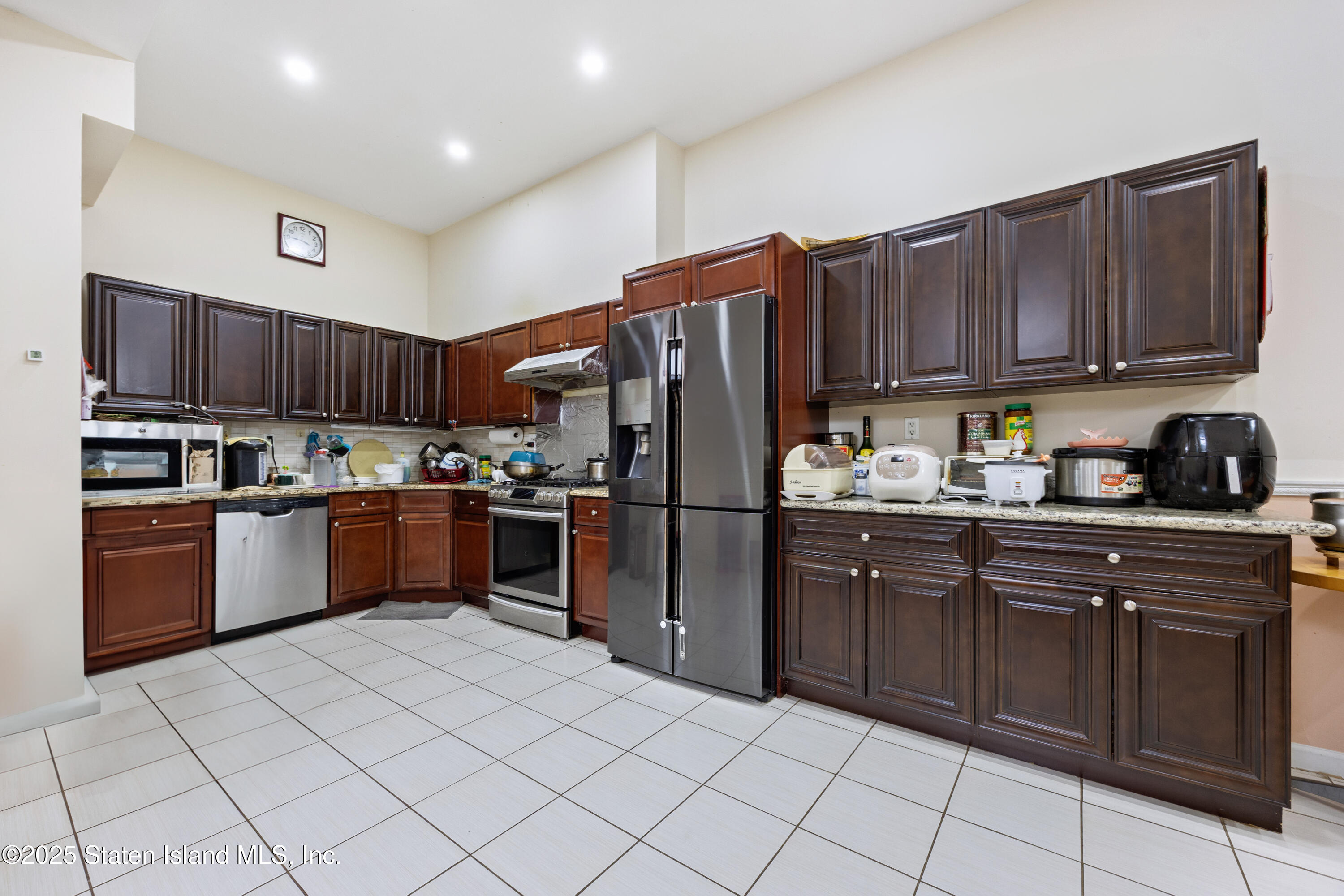 41 Burgundy Loop Staten Island, NY 10304 - Photo 18 of 29 a kitchen with a refrigerator sink and cabinets