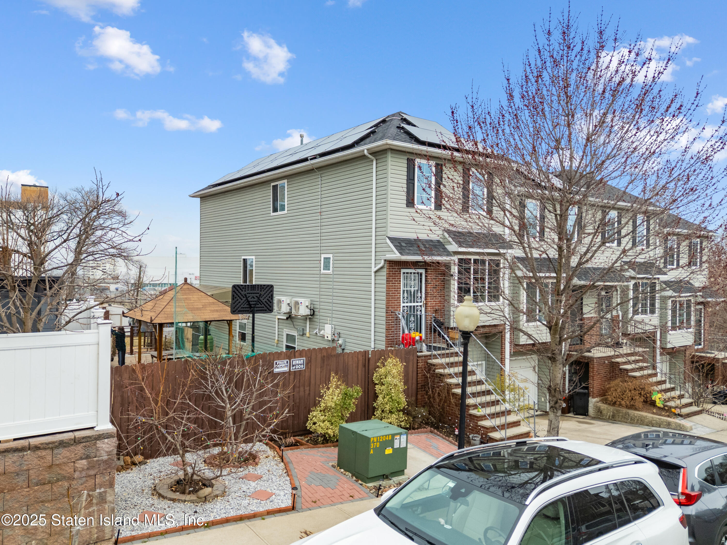 41 Burgundy Loop Staten Island, NY 10304 - Photo 2 of 29 a front view of a house with a yard
