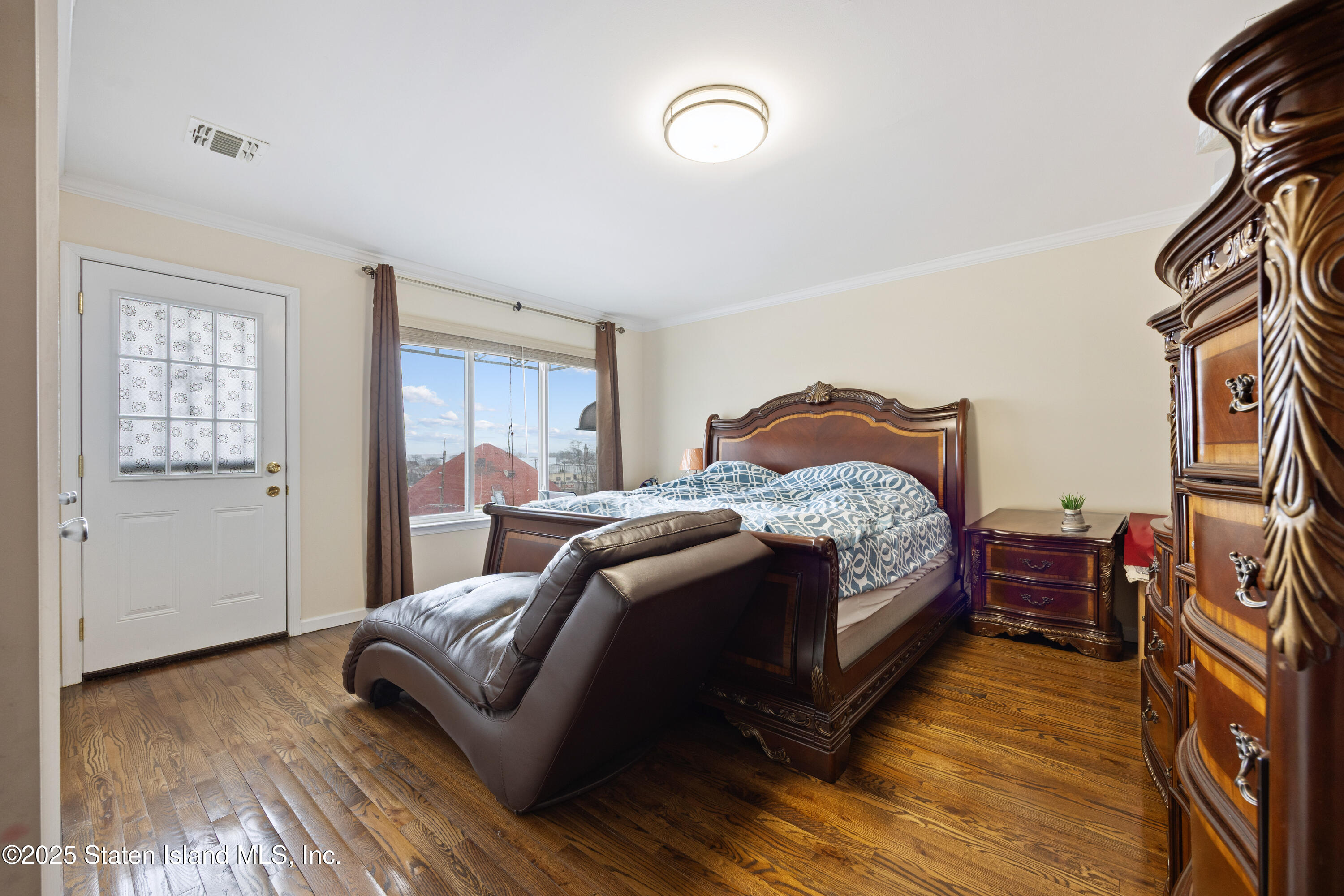 41 Burgundy Loop Staten Island, NY 10304 - Photo 6 of 29 a bedroom with a bed and a wooden floor