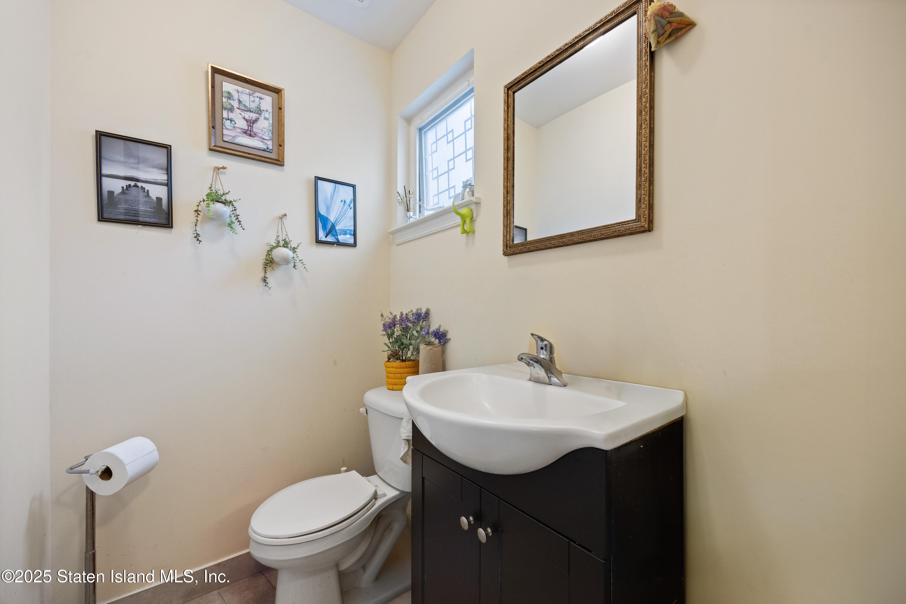 41 Burgundy Loop Staten Island, NY 10304 - Photo 7 of 29 a bathroom with a sink mirror and toilet