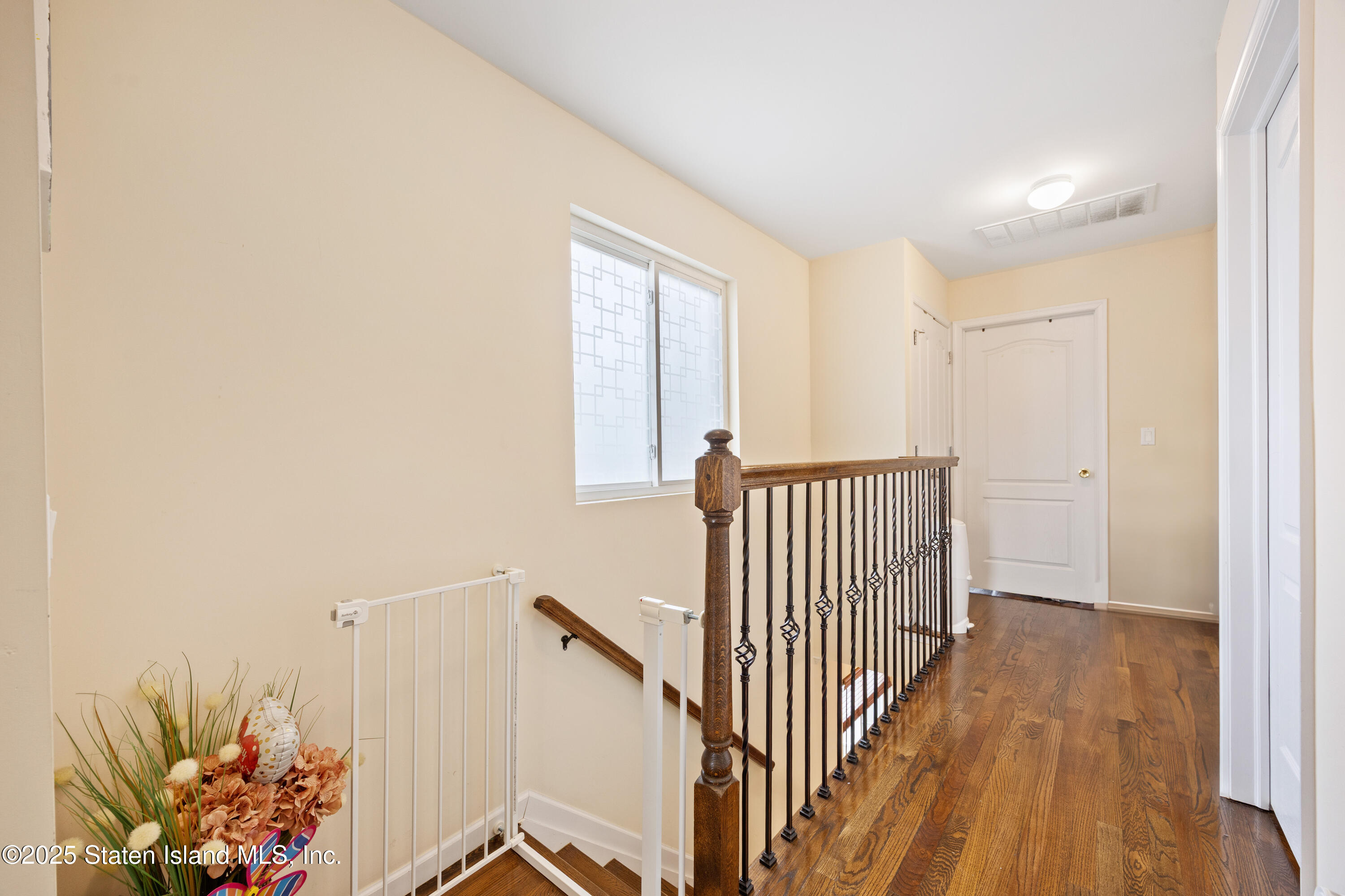 41 Burgundy Loop Staten Island, NY 10304 - Photo 8 of 29 a view of a hallway with wooden floor and a potted plant