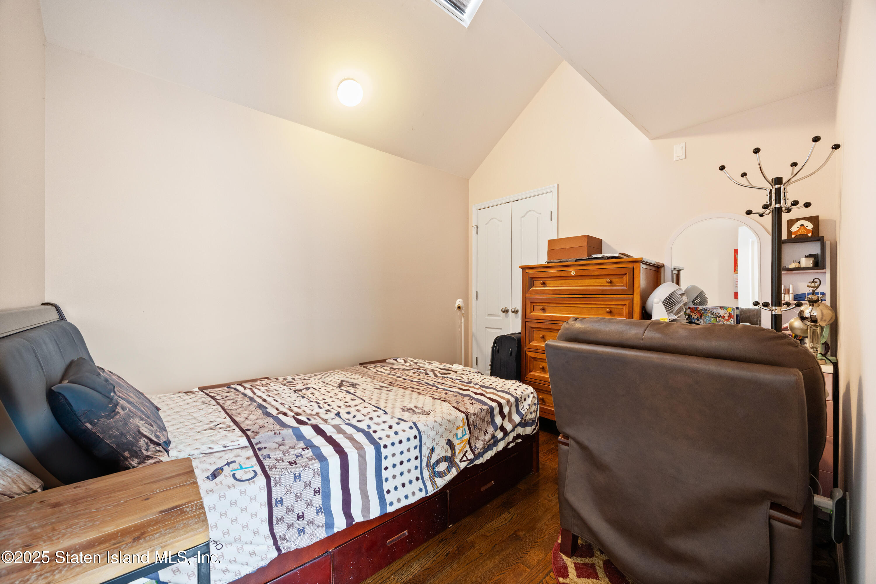 41 Burgundy Loop Staten Island, NY 10304 - Photo 10 of 29 a bedroom with a bed and wooden floor