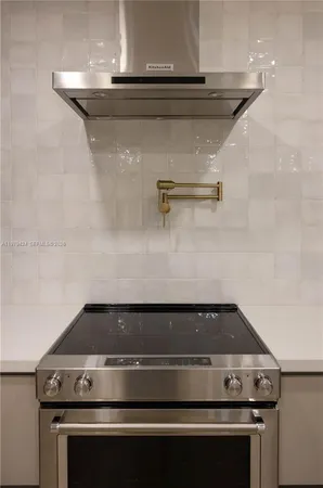 a stove top oven sitting inside of a kitchen