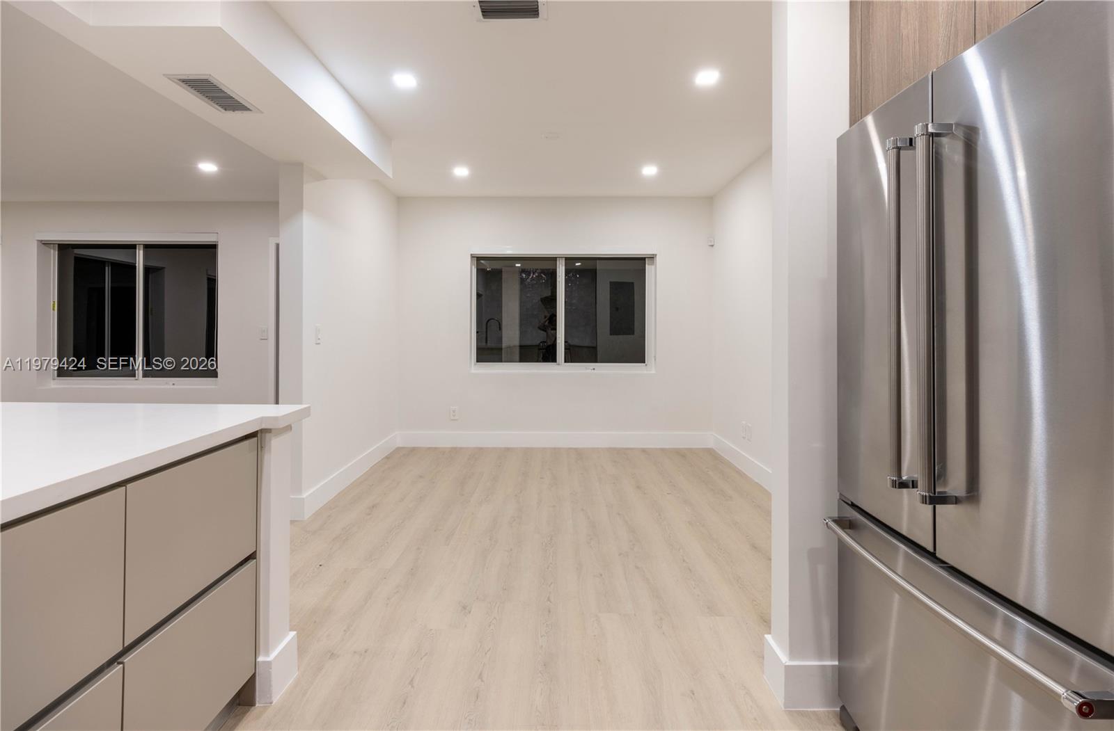 6070 Southwest 42nd Street Miami, FL 33155 - Photo 15 of 40 a view of an empty room with a window and wooden floor