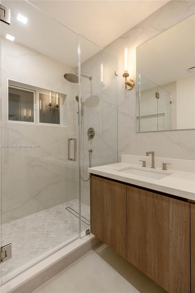 6070 Southwest 42nd Street Miami, FL 33155 - Photo 18 of 40 a bathroom with a shower sink and mirror
