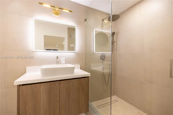 a bathroom with a double vanity sink and shower