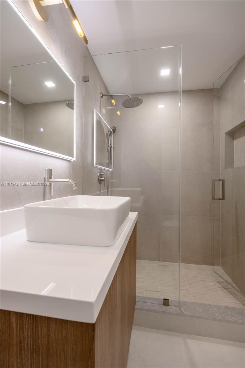 6070 Southwest 42nd Street Miami, FL 33155 - Photo 23 of 40 a bathroom with a double vanity sink and shower
