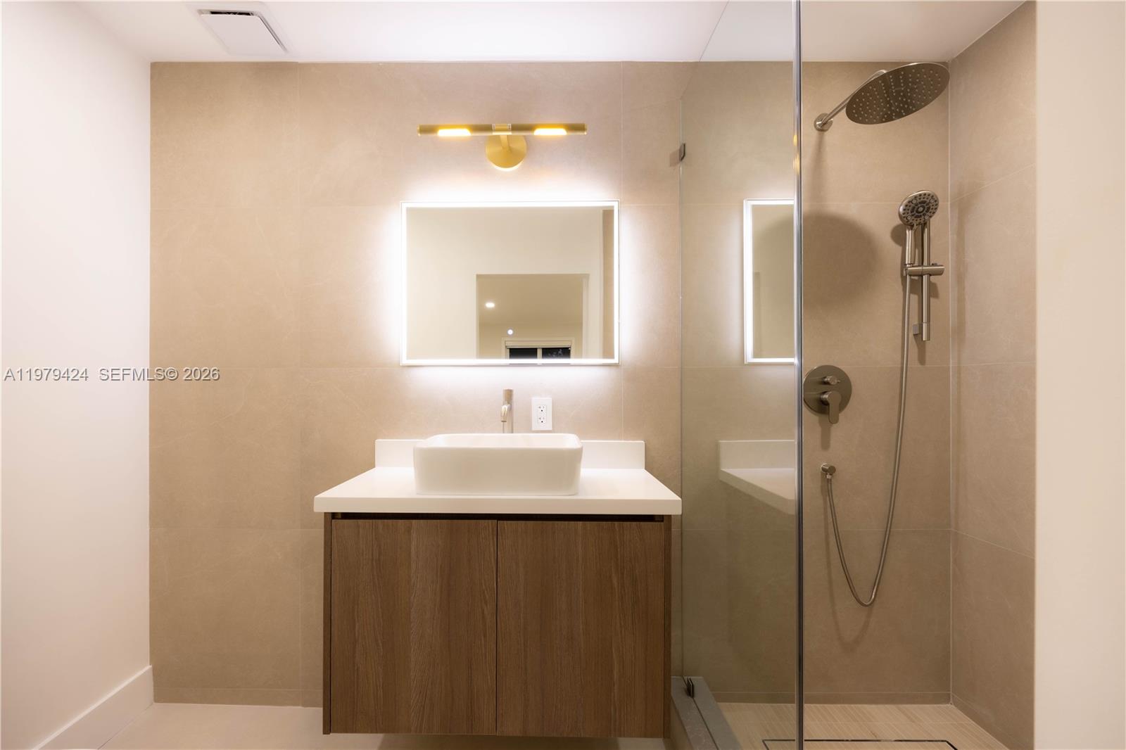 6070 Southwest 42nd Street Miami, FL 33155 - Photo 24 of 40 a bathroom with a sink a mirror and shower