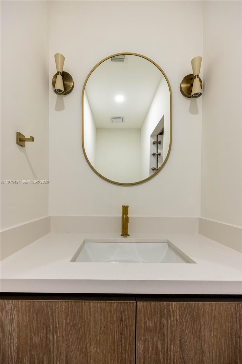 6070 Southwest 42nd Street Miami, FL 33155 - Photo 26 of 40 a bathroom with a sink and mirror