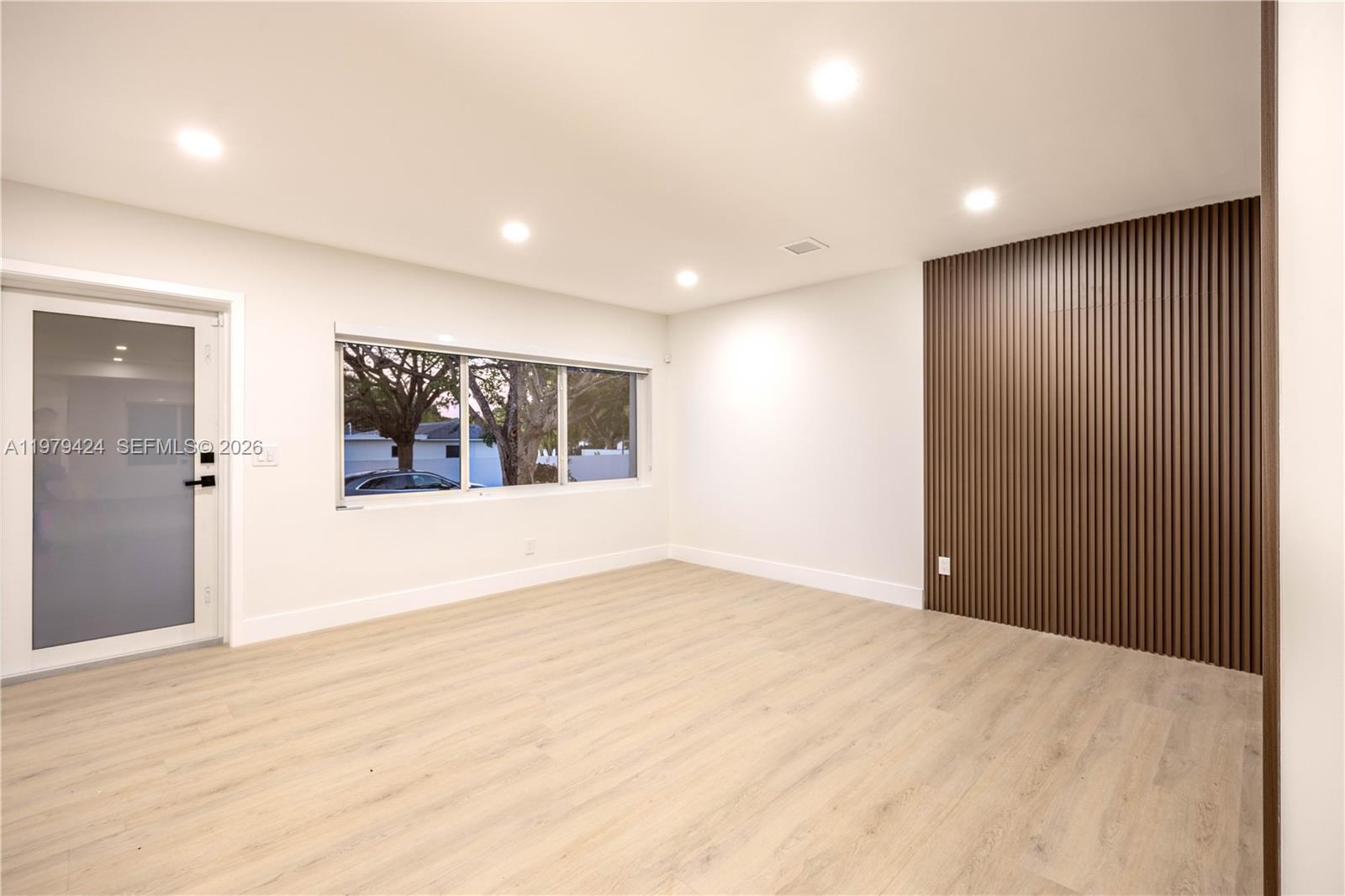 6070 Southwest 42nd Street Miami, FL 33155 - Photo 29 of 40 a view of an empty room with wooden floor