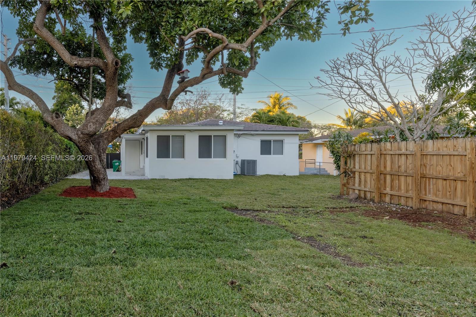 6070 Southwest 42nd Street Miami, FL 33155 - Photo 40 of 40 a view of a yard in front of a house with large trees