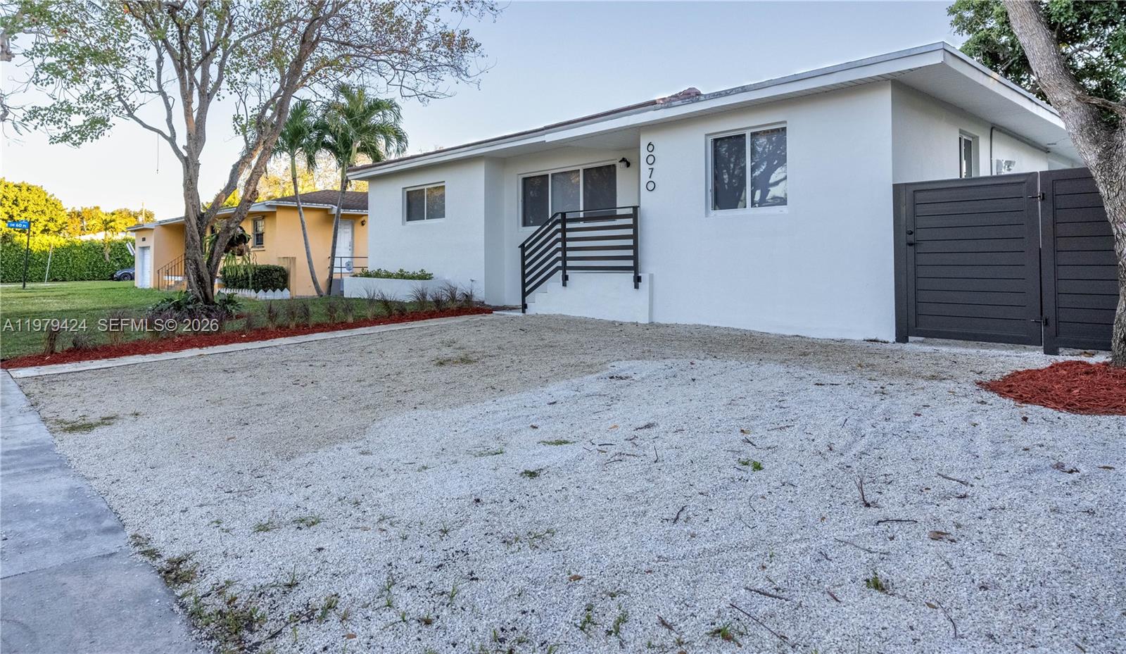 6070 Southwest 42nd Street Miami, FL 33155 - Photo 5 of 40 a view of a house with a backyard and tree