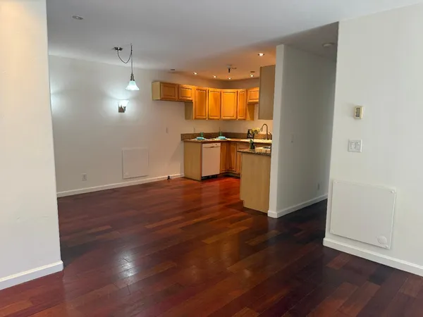 a kitchen with wooden floors and appliances