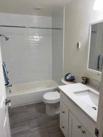 a bathroom with a sink a toilet and a bathtub
