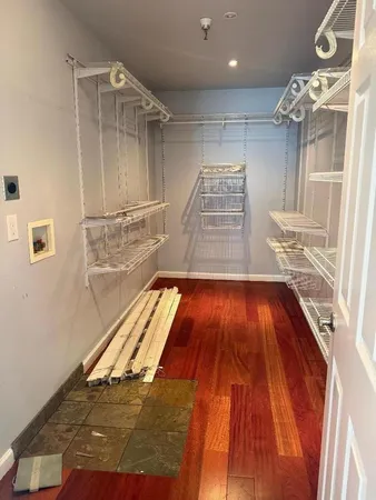 a view of a kitchen with wooden floor and staircase
