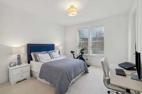 a bed room with a bed and a window