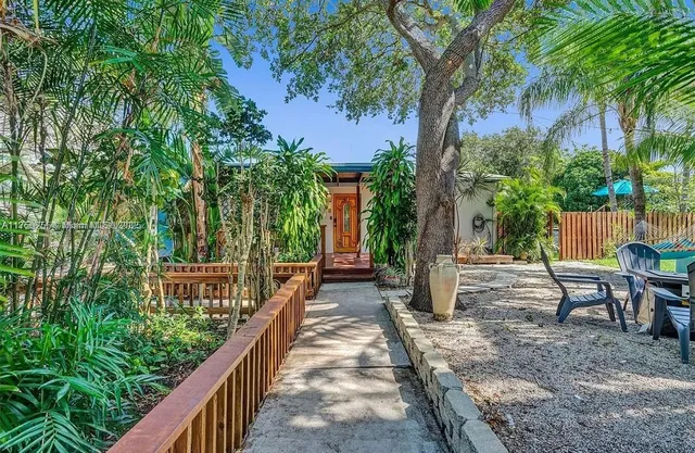 a view of a house with backyard and sitting area