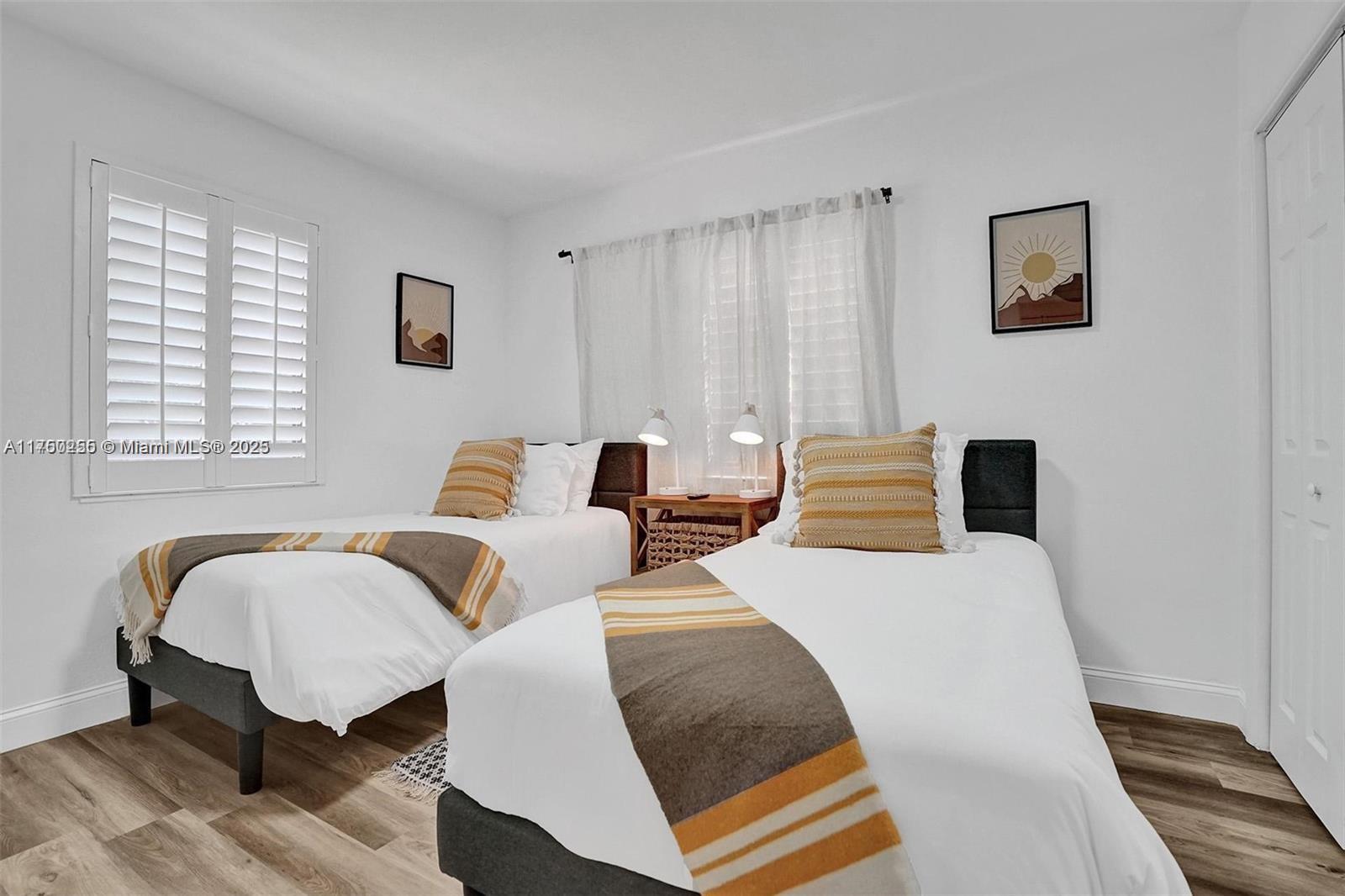 110 Southwest 5th Street Hallandale Beach, FL 33009 - Photo 14 of 26 a bedroom with two beds and a window