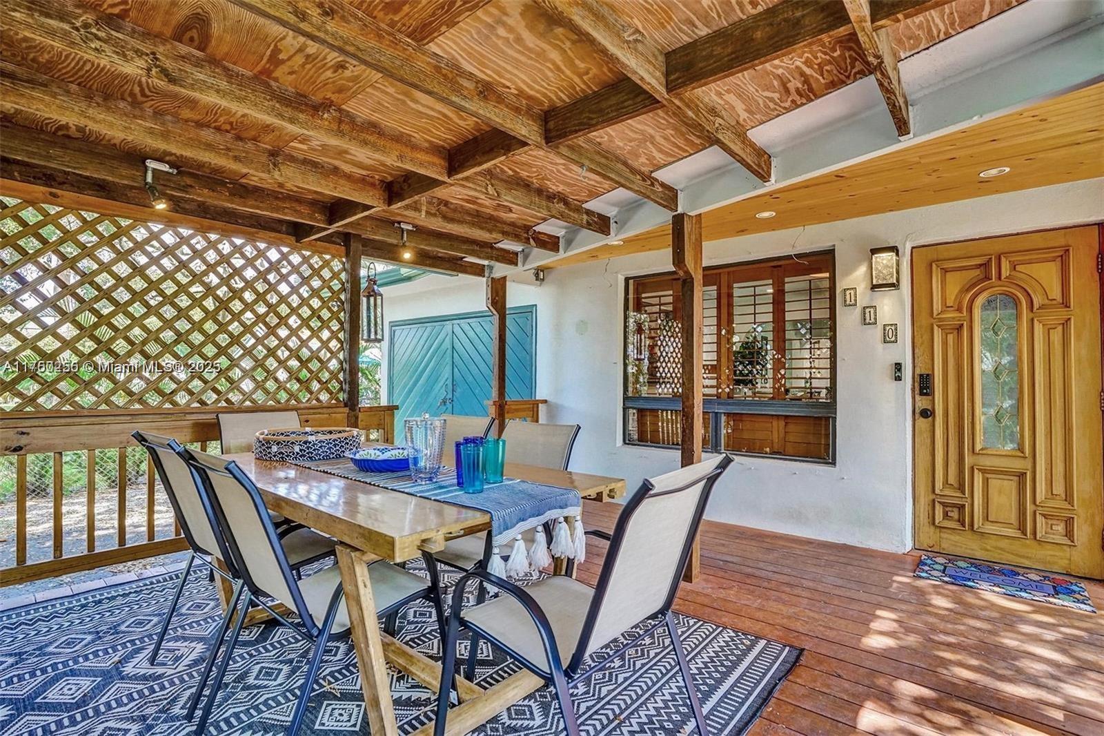 110 Southwest 5th Street Hallandale Beach, FL 33009 - Photo 17 of 26 a view of a dining room with furniture wooden floor and chandelier