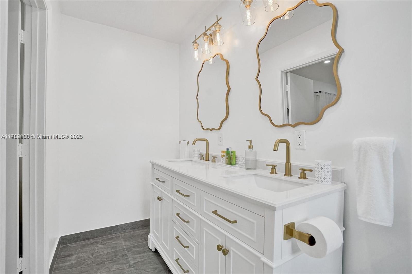 110 Southwest 5th Street Hallandale Beach, FL 33009 - Photo 24 of 26 a bathroom with a sink and mirror