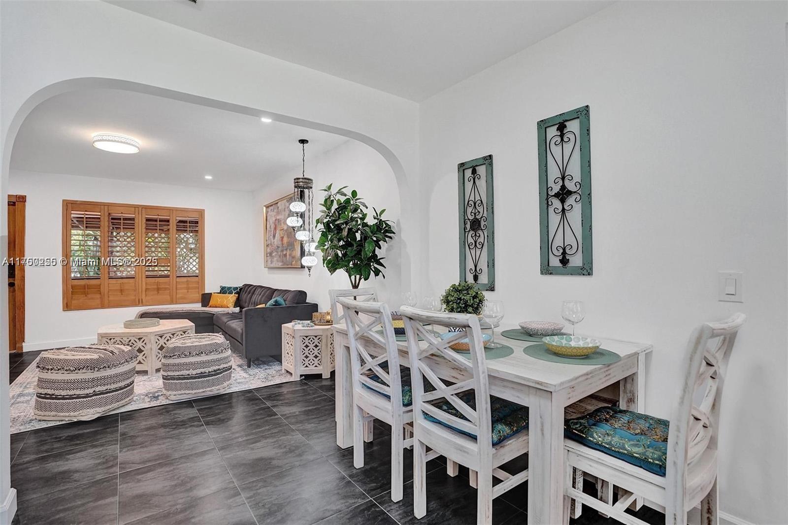 110 Southwest 5th Street Hallandale Beach, FL 33009 - Photo 26 of 26 a living room with furniture a table and a potted plant