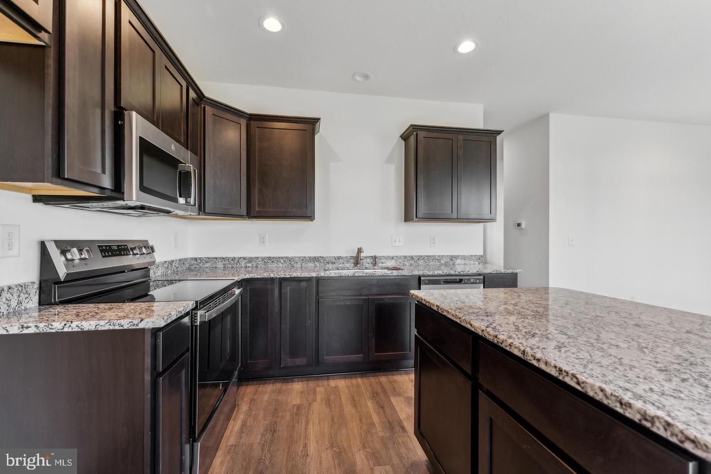 3637 Fieldstone Drive Dover, PA 17315 - Photo 4 of 19 a kitchen with stainless steel appliances granite countertop a sink stove and cabinets