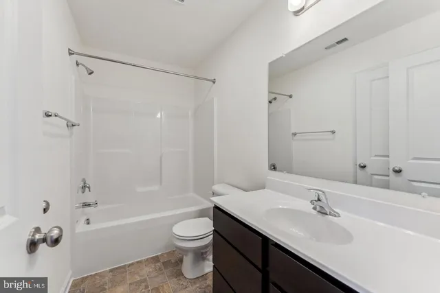 a bathroom with a sink toilet tub and shower