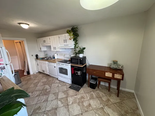 a kitchen with a sink cabinets and window