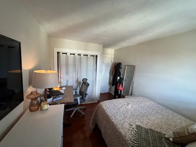 a bed room with a bed and a gym machine