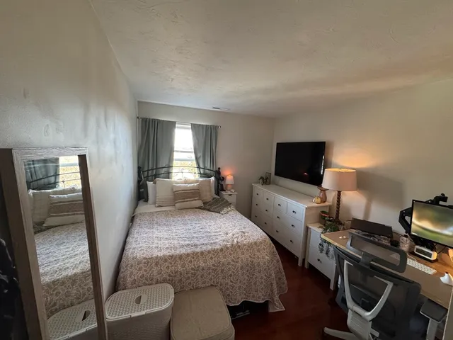 a bedroom with a bed and a television