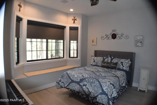 a bed sitting in a bedroom next to a window