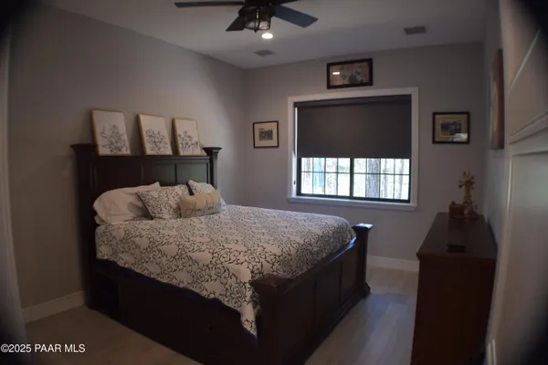 a living room with furniture and floor to ceiling window