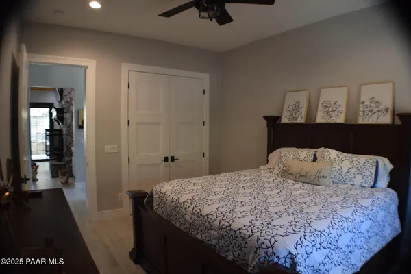 a large kitchen with stainless steel appliances kitchen island granite countertop a refrigerator a stove a sink dishwasher and a dining table with wooden floor