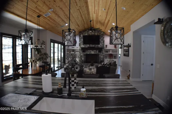 a bathroom with a granite countertop sink toilet and mirror