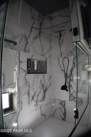 a spacious bedroom with a bed and a dresser