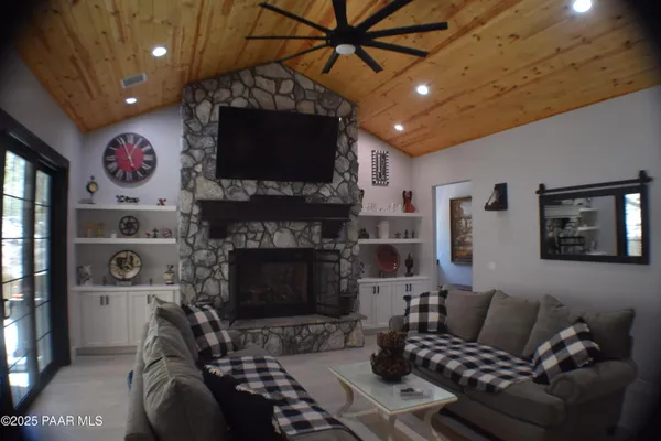 a living room with fireplace furniture and a flat screen tv