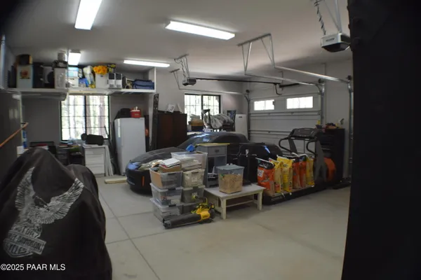 a living room with furniture a large window and a fireplace